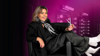 Cosmetology educator Becca holding hair cutting shears at Debutantes School of Beauty in DeKalb Illinois.