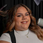 Cosmetology student holding hair styling tools during a photoshoot at Debutantes School of Beauty in DeKalb Illinois.
