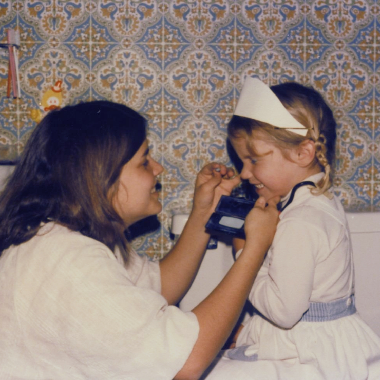 Debby Rogers shares a tender moment teaching her daughter Jaime, reflecting the creativity, mentorship, and family legacy that inspired Debutantes School of Beauty in DeKalb, Illinois.