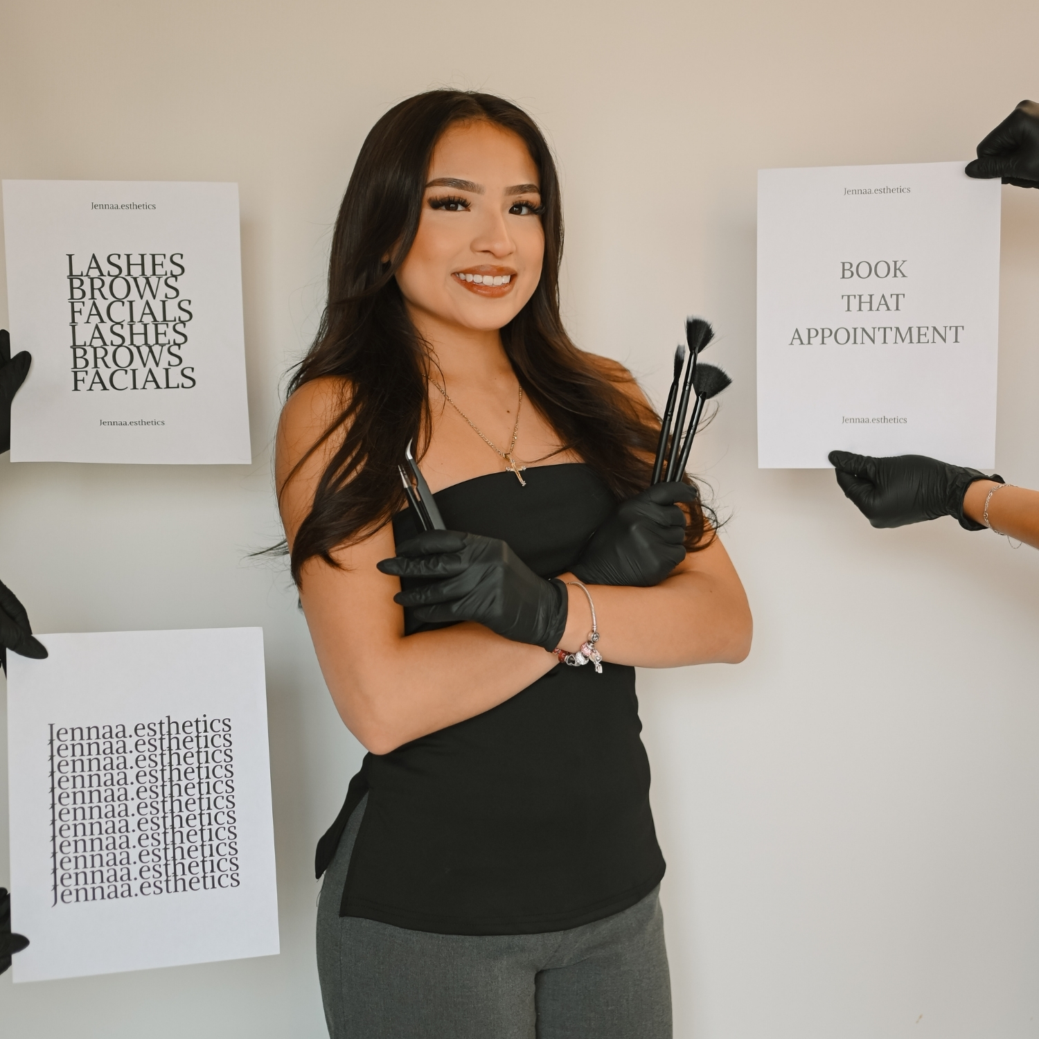 Esthetics student holding makeup brushes during a photoshoot
