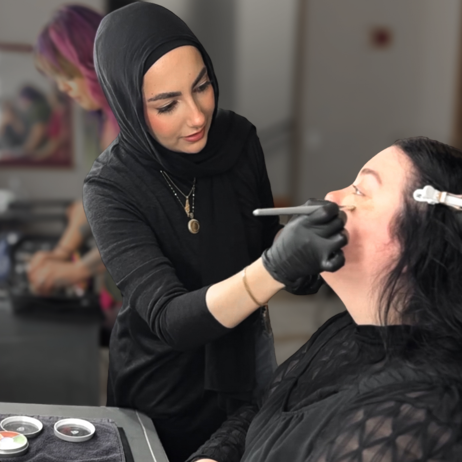 Beauty school student applying professional makeup during hands-on training at Debutantes School of Beauty.