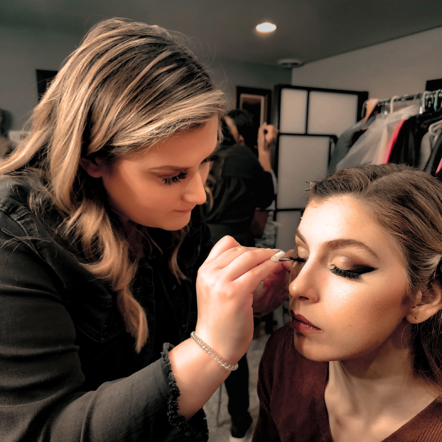 Esthetics student applying makeup during beauty training at Debutantes School of Beauty.