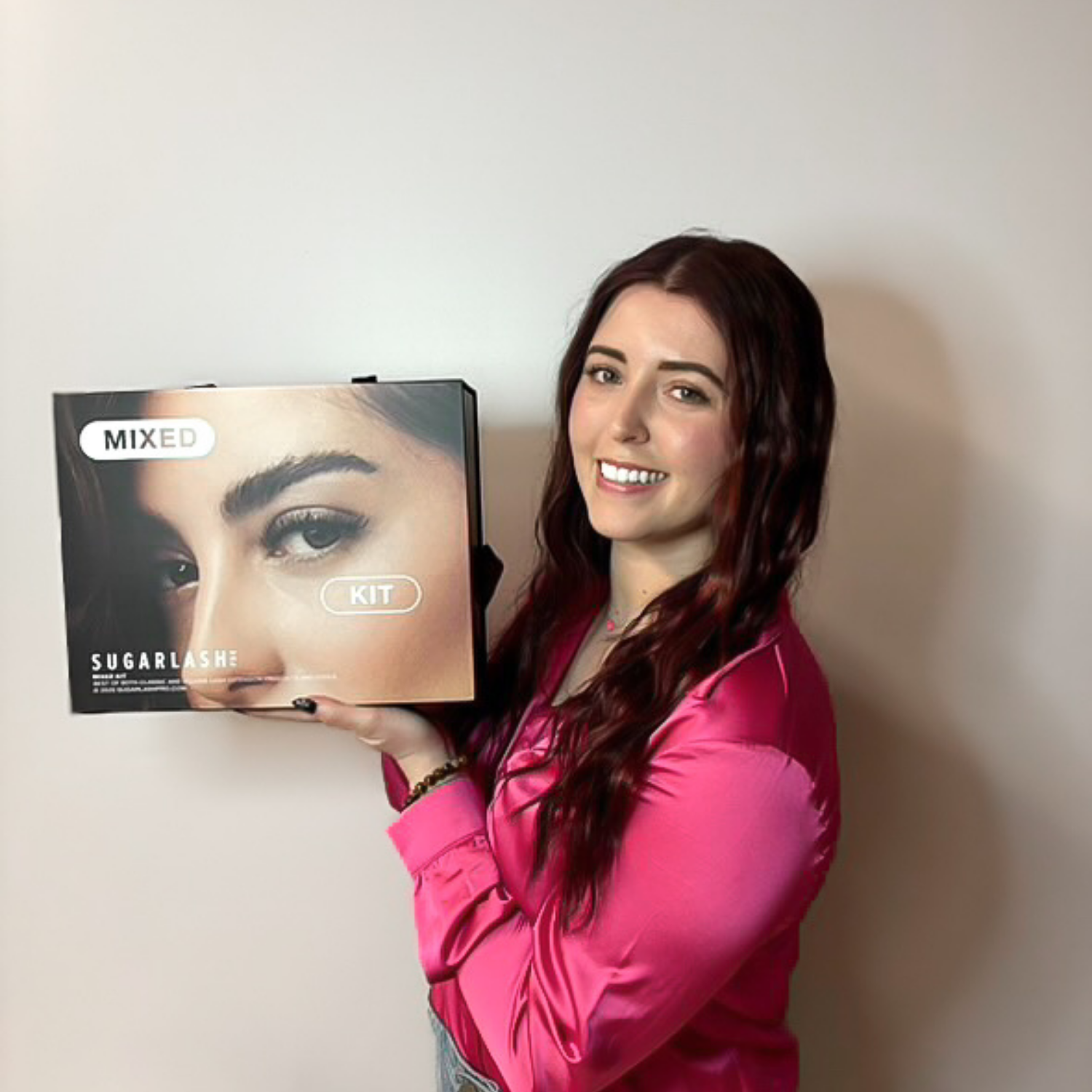 Student holding a Sugarlash eyelash extension training kit at Debutantes School of Beauty.