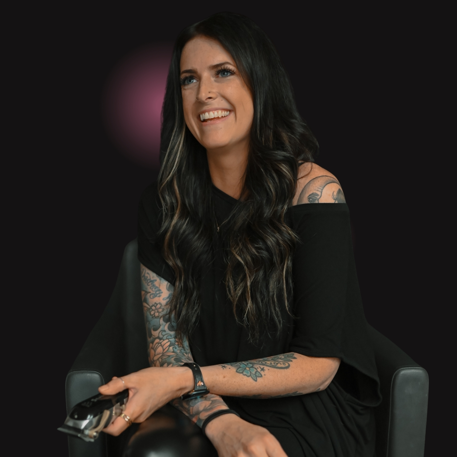 Shannon, a cosmetology educator at Debutantes School of Beauty in DeKalb Illinois, holding professional hair cutting shears while teaching students salon techniques.