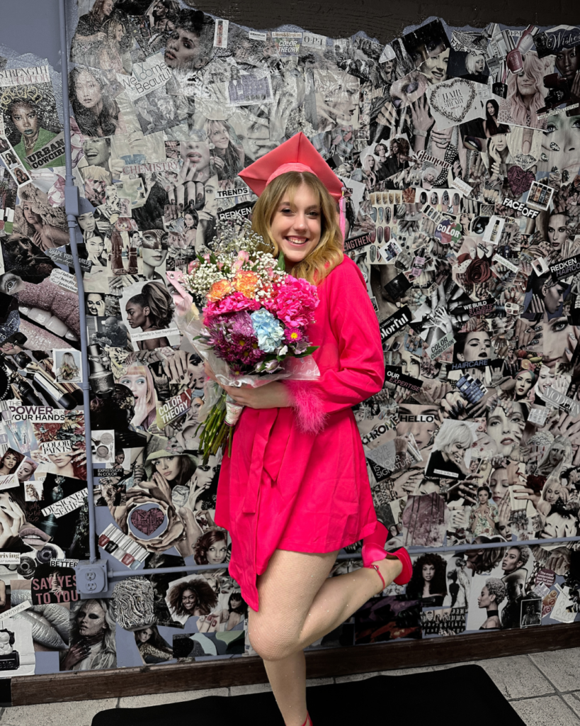 A student in a graduation outfit that is bright pink.