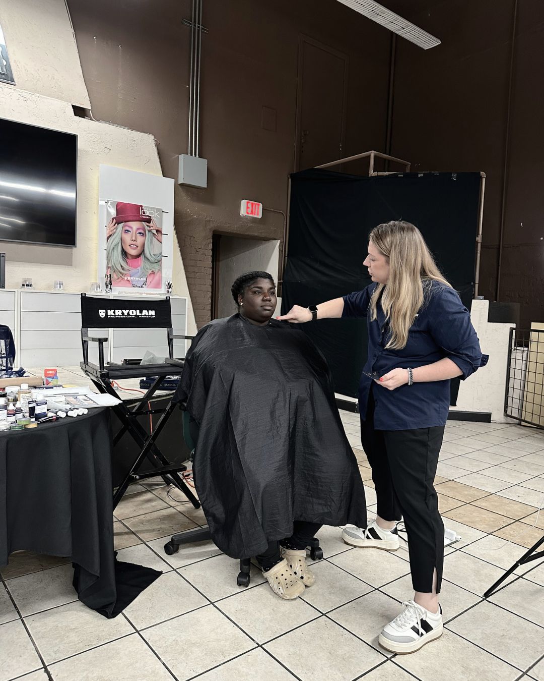 A female teaching a special fx makeup application
